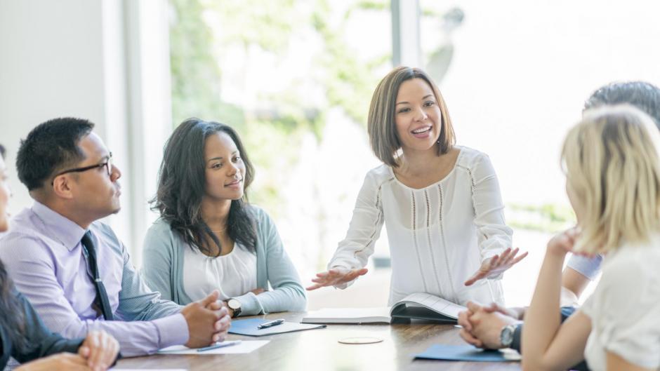 Diverse group of professionals brainstorm together.