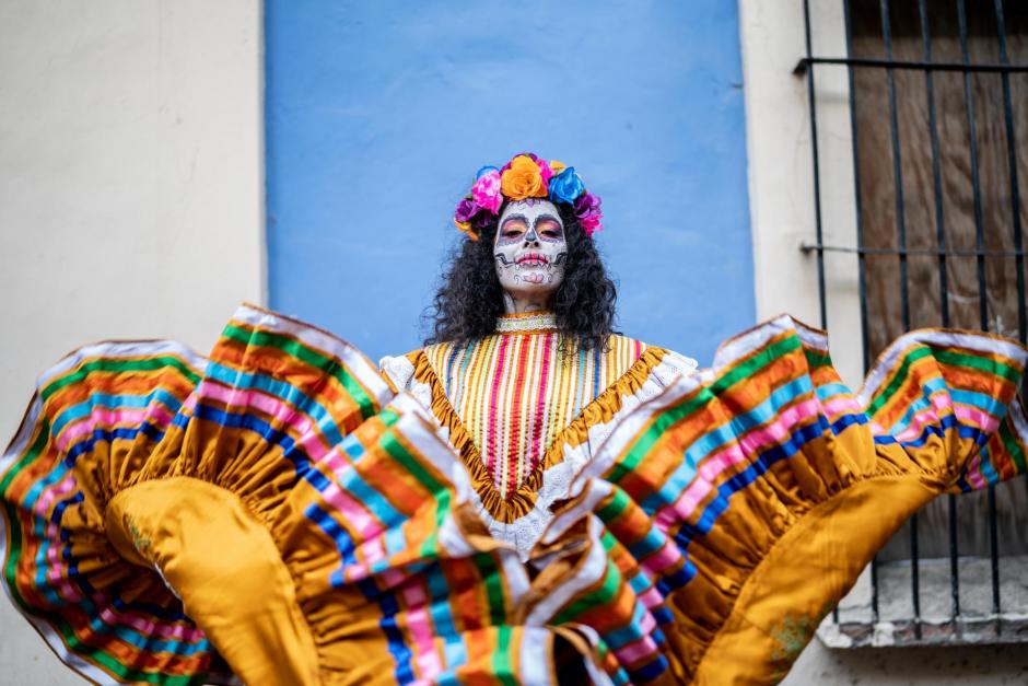 Portrait of a mid adult woman dancing and celebrating the day of the dead