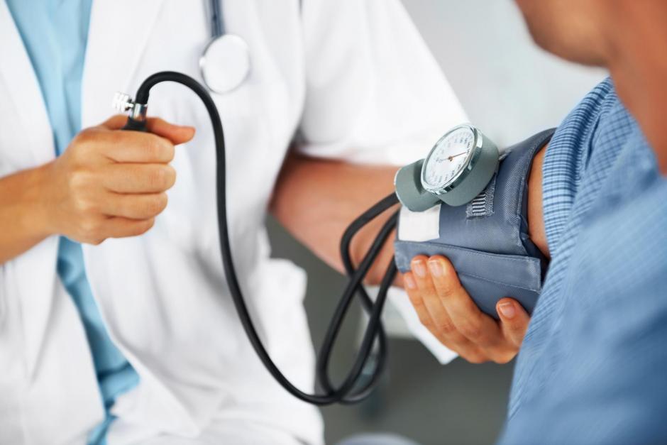 A doctor listening to his patient's heartbeat with a stethoscope