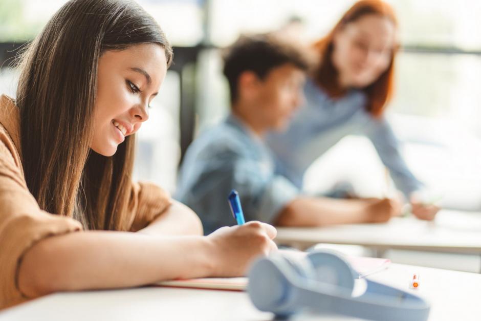  A teenage girl in classroom doing homework