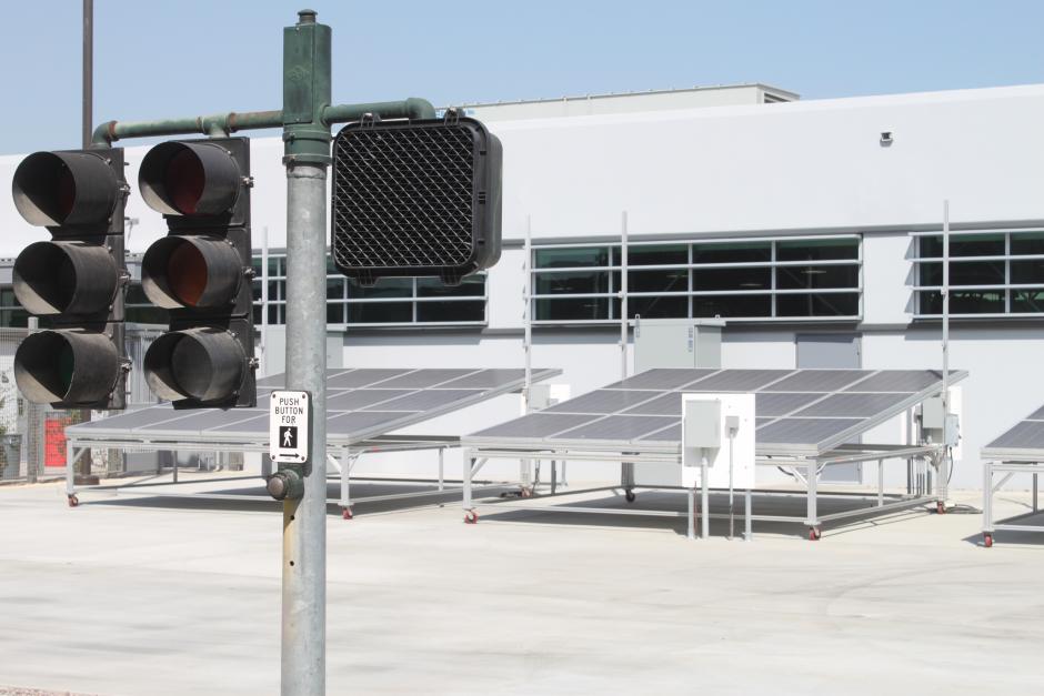 An courtyard outside the Electrical Technology building with traffic signals and solar panels used for teaching purposes.