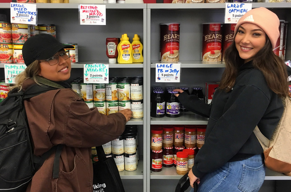 Two LBCC students standing in front of a shelf of food.