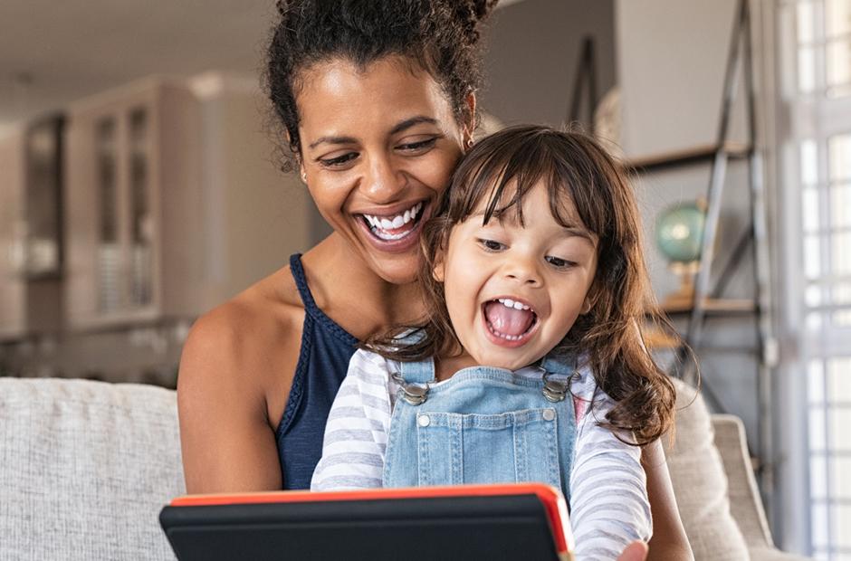 A mother and daughter exploring foster care resources online