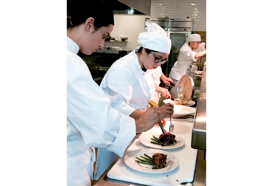 Advanced Culinary Students Utilizing Their Plating Skills in the Advanced Restaurant Practicum Class