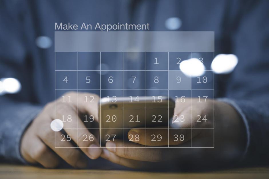 Businessman using smartphone to reserve business schedule plan on virtual screen calendar , Project management concept.