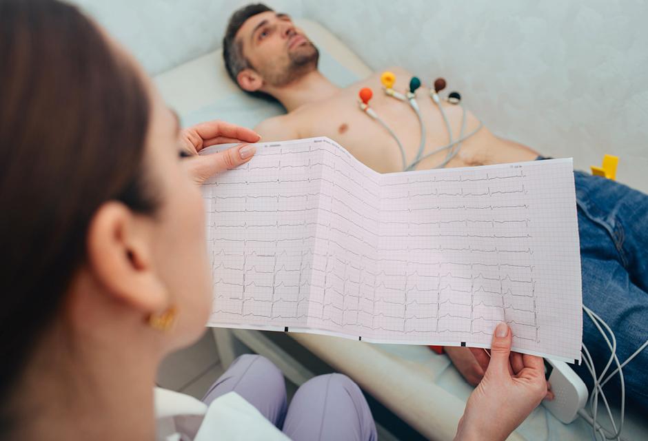 Patient getting heart rate monitored at hospital. Close-up of electrocardiograms report